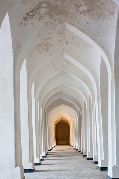 White Arabian arches in Kolon mosque. Bukhara. Uzbekistan. Central Asia.