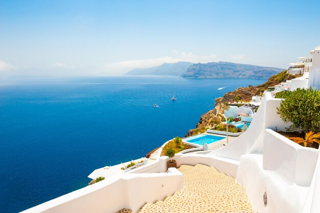 White architecture and blue sea on Santorini island, Greece. Stairs to the sea. Summer holidays, travel destinations concept