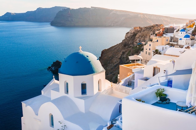 White architecture in Santorini island Greece Church with blue dome n Oia town Sea view at sunset