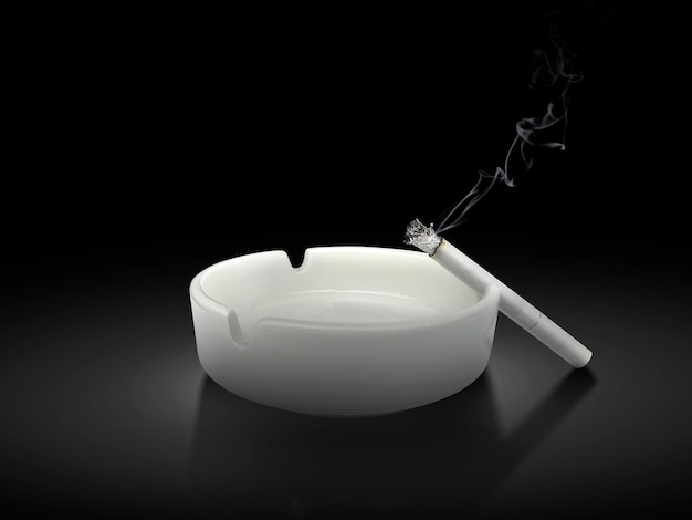 White ashtray and cigarette on black background