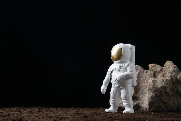 white astronaut on moon on a dark  fantasy sci fi