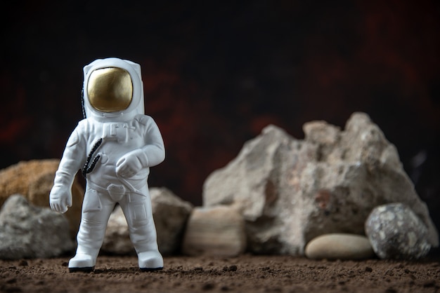 White astronaut with rocks on moon dark  fantasy cosmic sci-fi