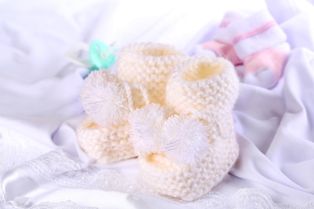 White baby boots on cloth closeup