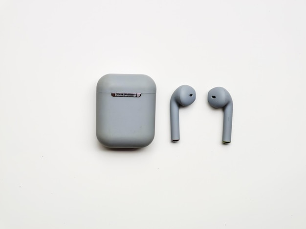 Photo white background with grey color ear buds. slightly blur at the back.