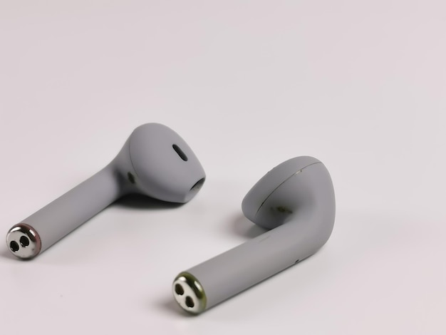 White background with grey color ear buds. Slightly blur at the back.