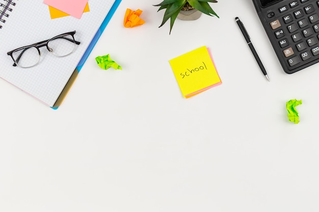 White background with school supplies top view