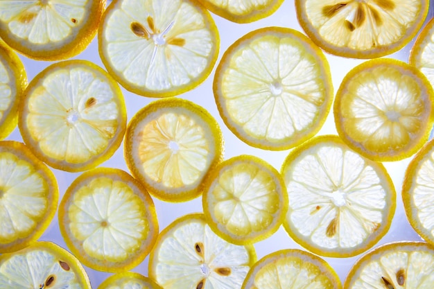 White background with see through lemon slices and visible seeds macro asset