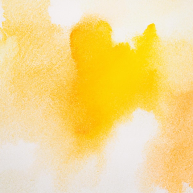 A white background with a yellow and orange paint texture.