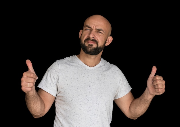 White bald man with a beard in a white T-shirt keeps fingers up