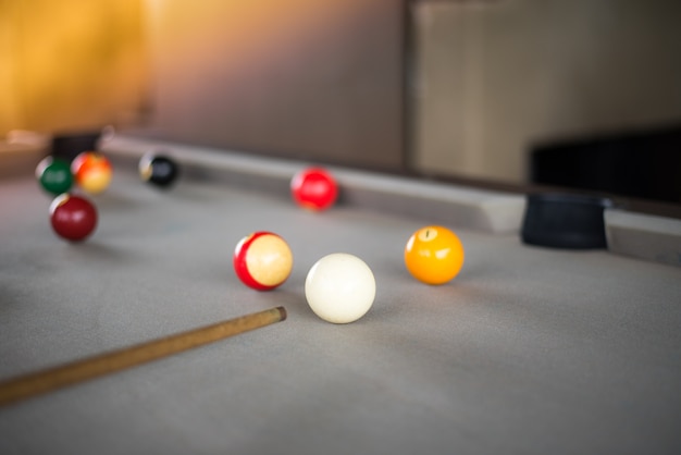 White ball hit a yellow ball on pool table