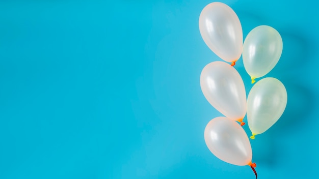 White balloons on blue background