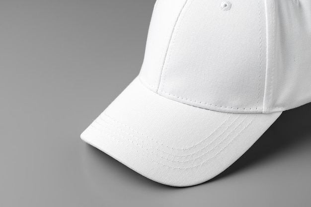 White baseball cap on grey background