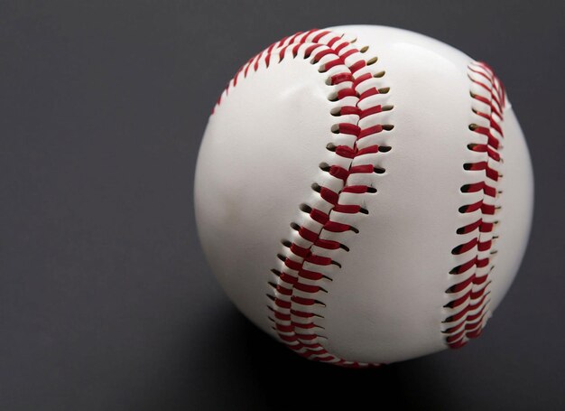 A white baseball with red stitching on it