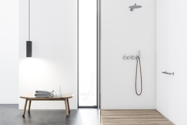 White bathroom interior with a wooden and concrete floor, a shower stall and a table with a stack of towels. 3d rendering