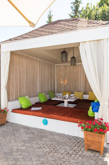 White beach umbrellas and lounge chairs at the swimming pool in hotel and resort