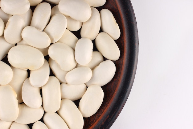 White beans in a plate on a white surface