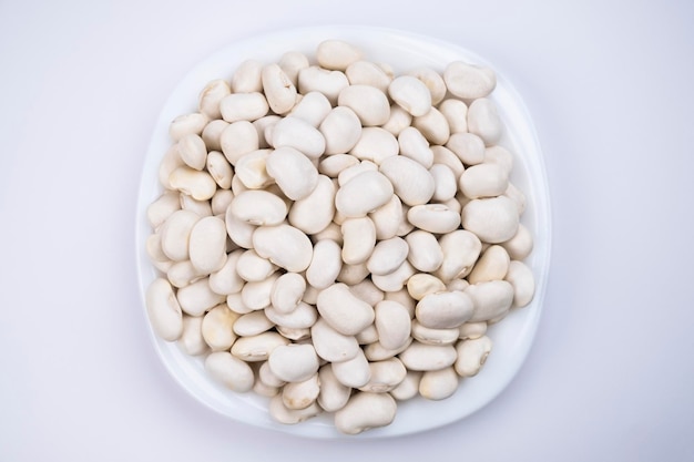 white beans on a white plate, close-up