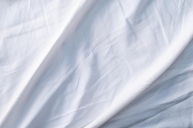 White bed linen gradient texture blurred curve style of abstract luxury fabricWrinkled bed linen and dark gray shadowsbackground