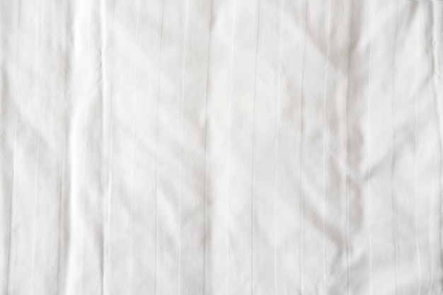 Photo white bed linen sheet as texture or background crumpled blank bedclothes top view