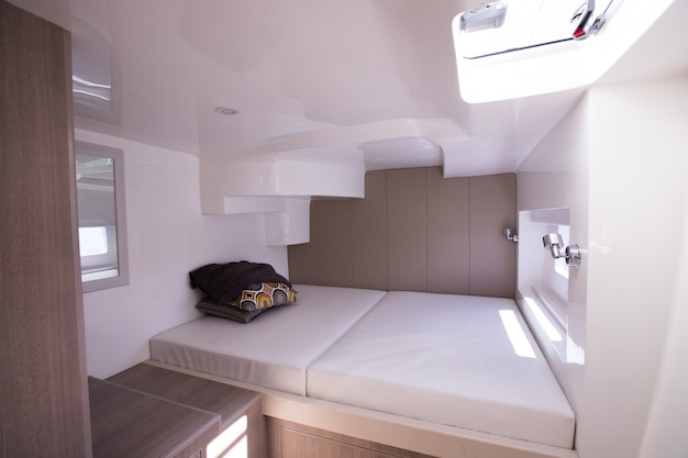 White Bedroom inside Yacht cruise with Windows