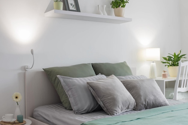 White bedroom with gray and green linens