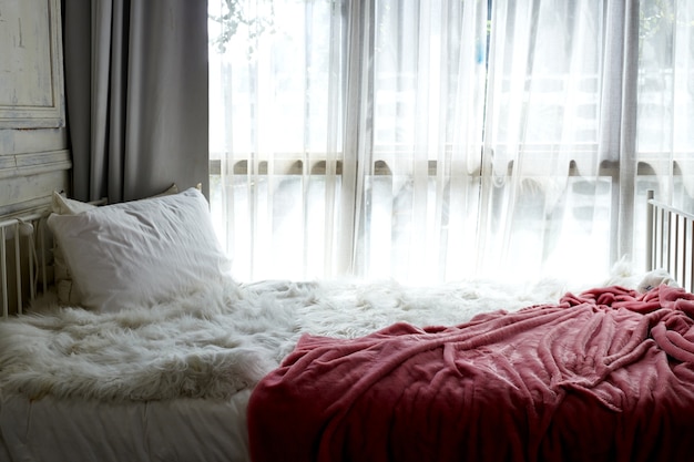 white bedroom with white curtain on window