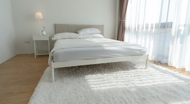 White bedroom with white curtains and white pillows