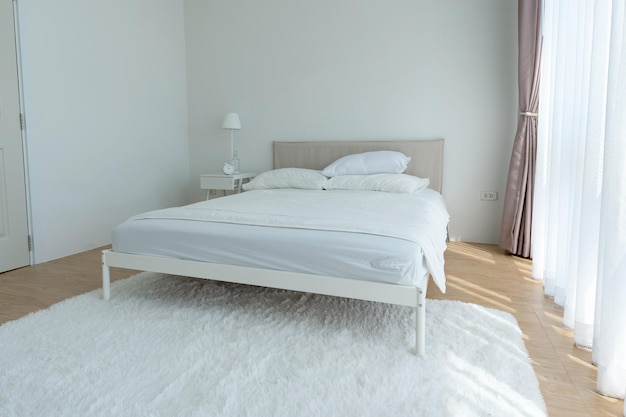 White bedroom with white curtains and white pillows