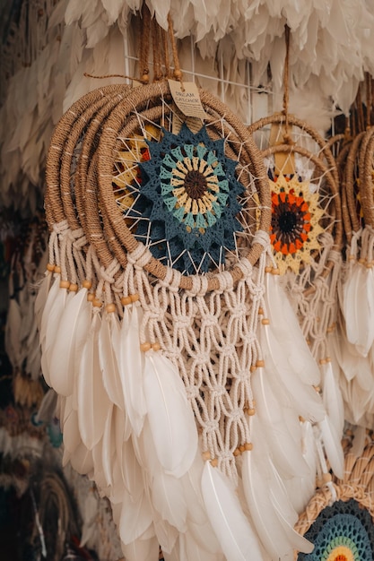 White beige dream catchers hanging on the counter of a street store