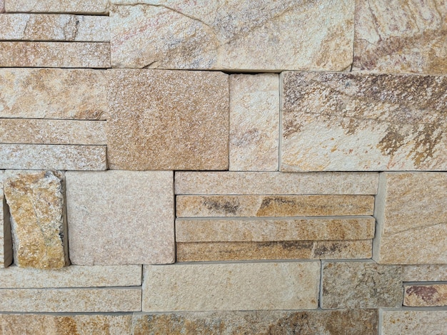 White and beige mix of natural stone stacked against stone wall