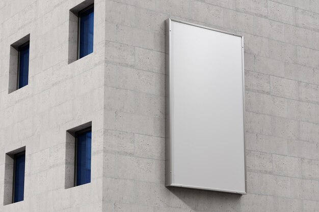 A white billboard on a wall with blue windows.