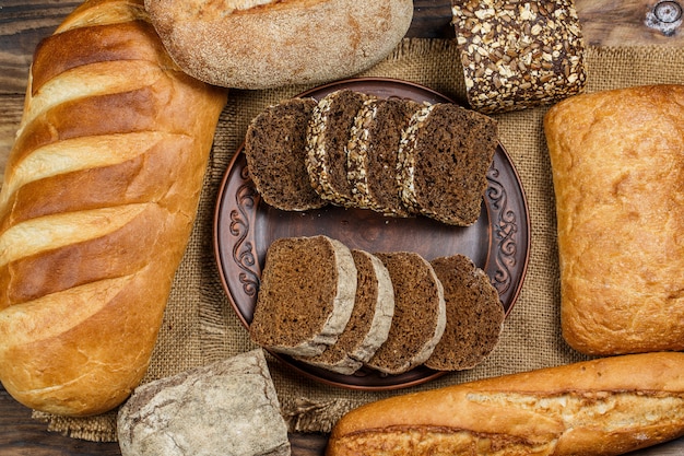 White and black fresh bread on a wooden table