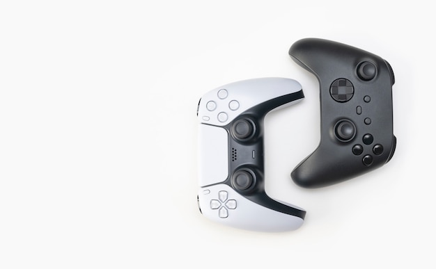 White and black game controllers on white background