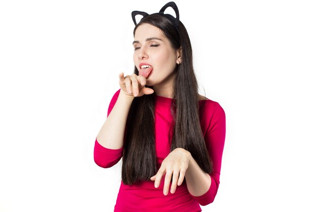 White black haired beautiful young woman in red shirt with cat ears head bend.