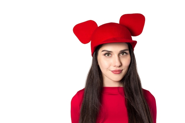 White black haired beautiful young woman with mouse ears hat on a white background.