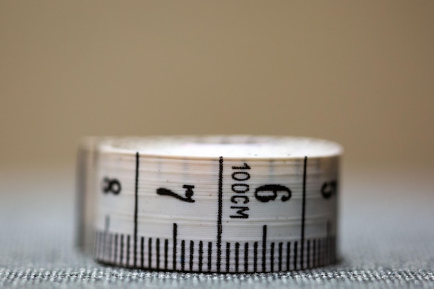 A white and black measuring tape with the number 6 on it