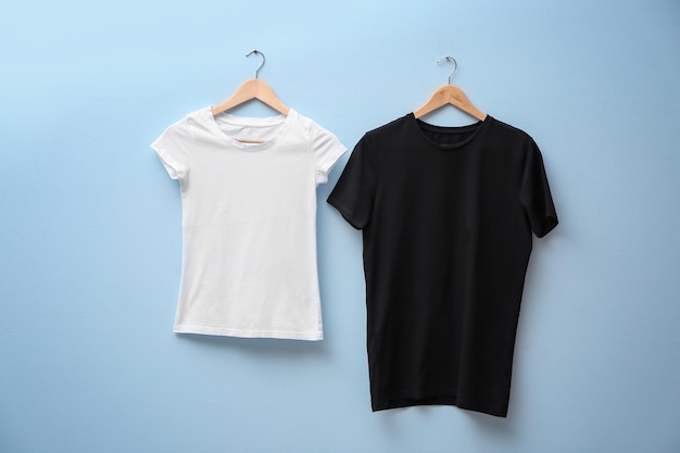 White and black tshirts on color background Mock up for design