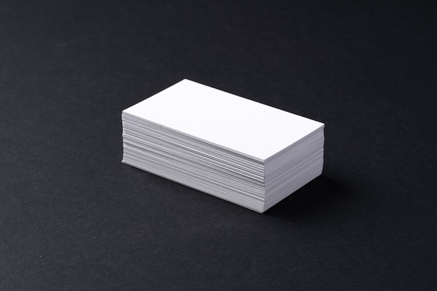 White blank business cards on dark black table