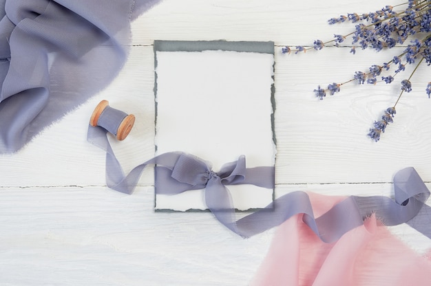 White blank card ribbon bow with pink and blue fabric and lavender flowers