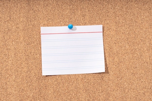 White Blank note on a cork board for adding text and push pin