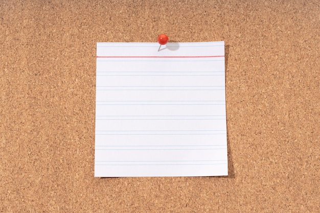 White Blank note on a cork board for adding text and push pin