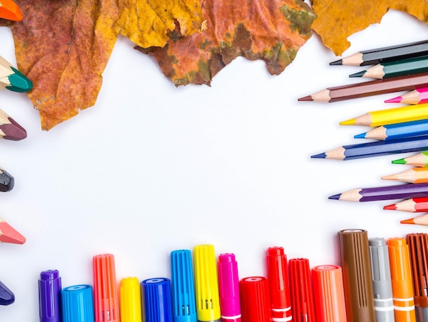 White blank page colorful pencils markers and autumn leaves mockup composition Back to school concept top view