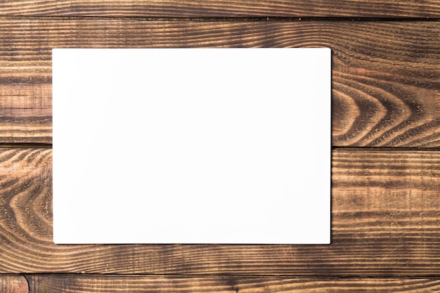 White blank paper on wooden table