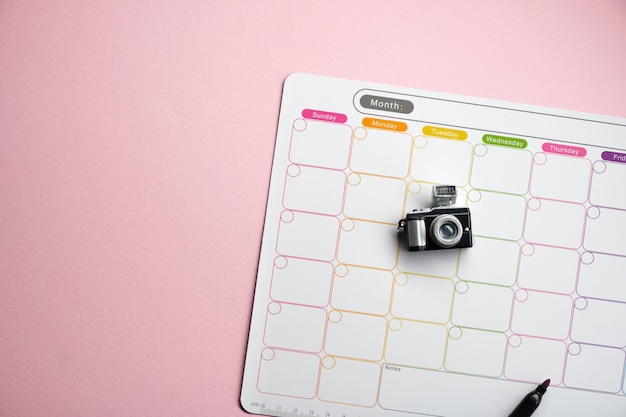 Photo white blank weekly planner against pink background