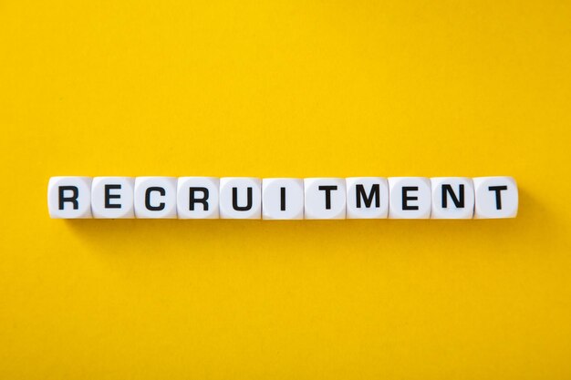 White block with word Recruitment on yellow background