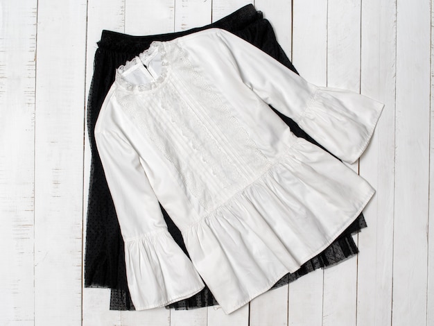 Photo white blouse on black skirt.