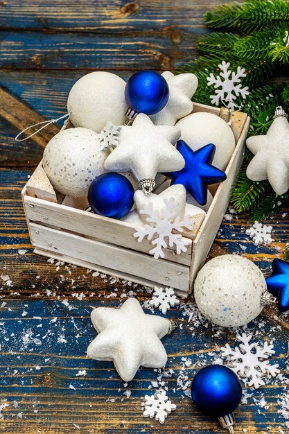 white and blue christmas balls and stars, fir tree branches and snowflakes. close up