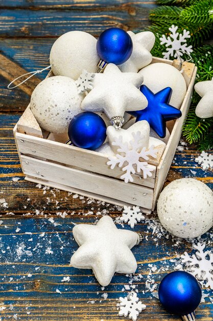 white and blue christmas balls and stars, fir tree branches and snowflakes. close up