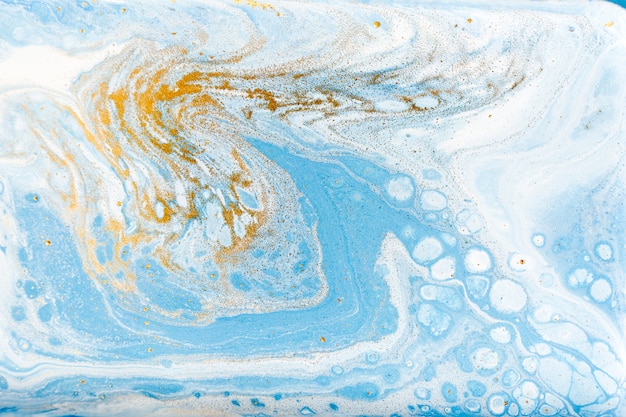 Photo white, blue and gold marbling. golden marble liquid texture.