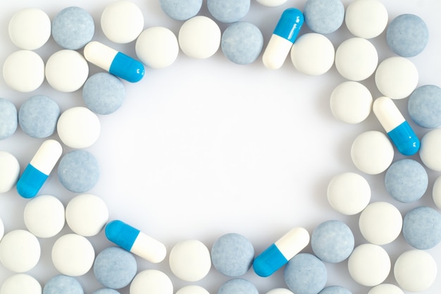 Photo white and blue pills on a light surface